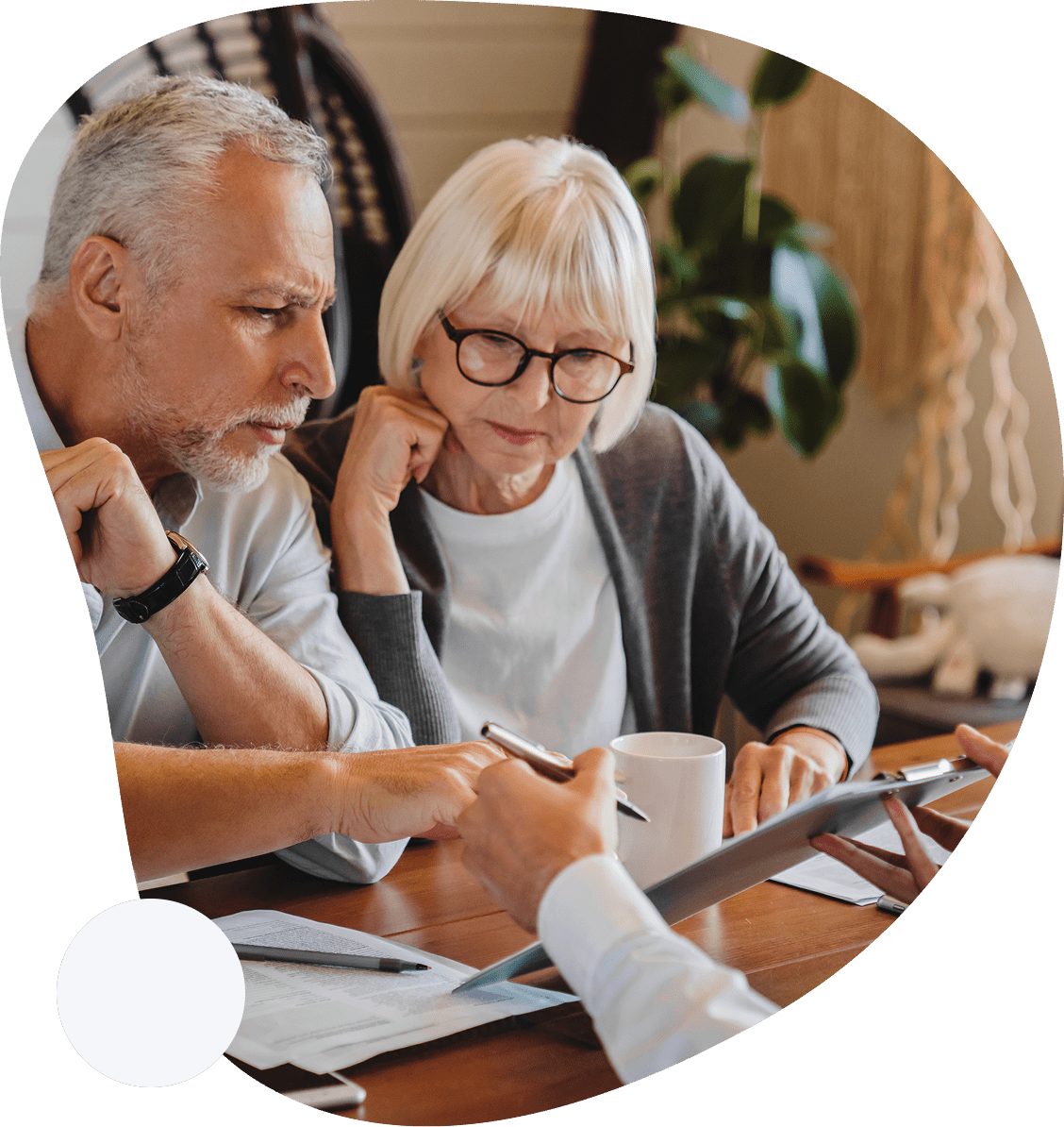 4 A man and woman sitting at a table looking at paperwork.